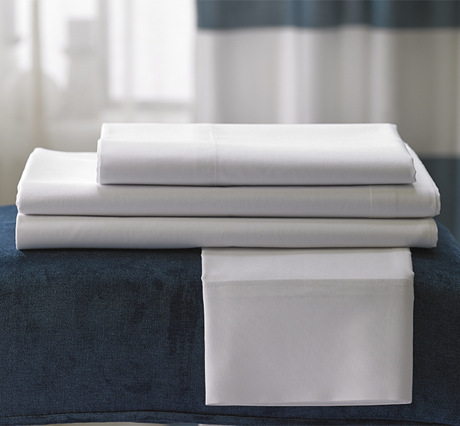 Linens on top of a blue coverlet